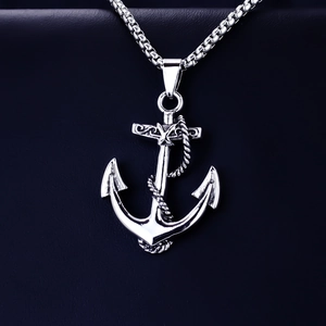 Macro shot of a punk-style silver anchor pendant with rope details and vintage engravings