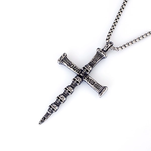 Detailed macro view of vintage skull cross pendant with DEAD engraving on a silver box chain