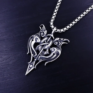 Gros plan du pendentif épée viking avec nœuds celtiques sur fond de bois sombre