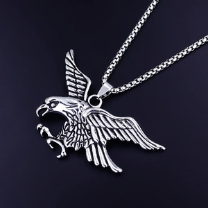 Detailed macro view of the silver eagle pendant with intricate feathers and a box chain