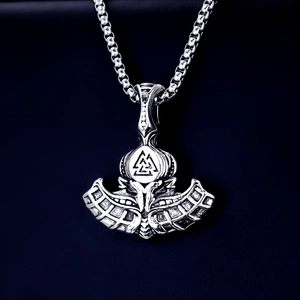 Detail view of silver stainless steel Viking Thor axe pendant with Valknut symbol on leather