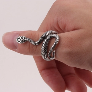 Detailed close-up of retro silver snake ring showing intricate scale textures on finger