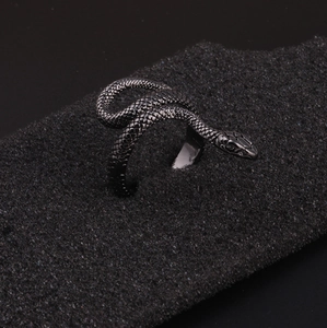 Gothic punk snake ring in black finish with detailed scales on textured background