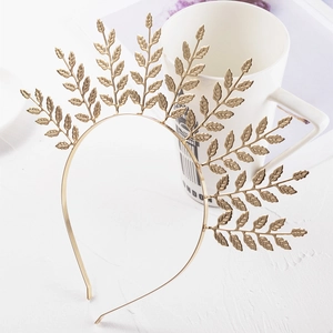 Detail view of golden metal leaf headband with symmetrical radiant olive leaves for brides