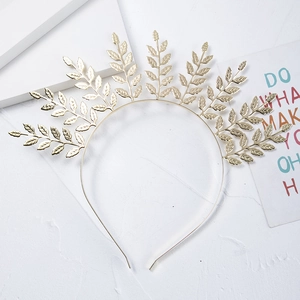 Detail of bohemian gold leaf bridal headband with radial metallic branches and textures