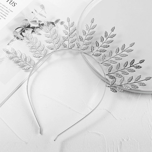 Detailed close-up of a silver laurel leaf metal headband for bridal wedding photography