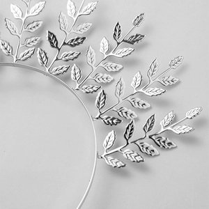 Detailed macro view of silver metallic bridal leaf headband with intricate vein textures