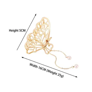 Pince à cheveux papillon en métal doré avec pompons en perles et largeur de 16 cm