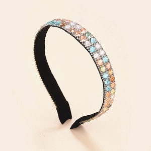 Close-up of luxury wide headband with colorful square crystals and silver rhinestones