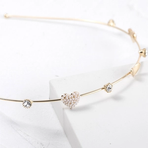 Elegant gold metal headband featuring heart-shaped pearl clusters and crystal rhinestones