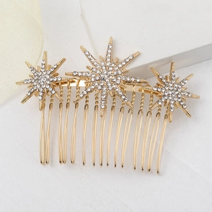 Gros plan d'un peigne à cheveux doré en forme d'étoile avec des strass sur pierre blanche