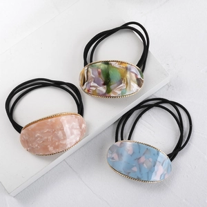 Three-piece acetate marble oval hair ties with gold trim and elastic black hair bands