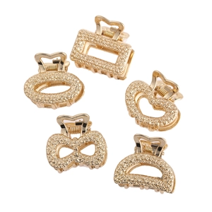 Close-up of five-piece gold mini hair clips with various shapes and glitter texture