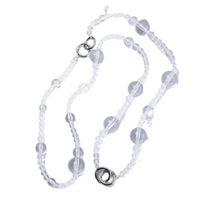 Macro shot of minimalist clear acrylic beaded choker necklace with silver circular clasp