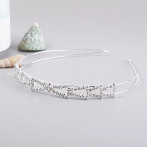 Close-up of silver bridal headband with sparkling rhinestones and geometric patterns