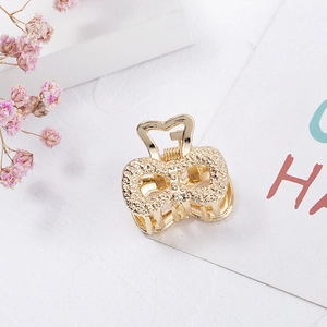 Elegant gold mini hair claw clip with rhinestones in butterfly design for women