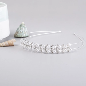 Detail of silver double-layered headband with elegant white pearls and sparkling rhinestones
