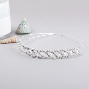 Detail of silver bridal headband with sparkling rhinestones and white pearls on thin metal bands