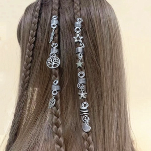 Silver hollow dreadlock hair rings with charms including tree of life and leaf on dark braids