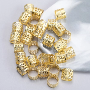 Detailed close-up of hollow geometric golden metal hair rings for braid decoration