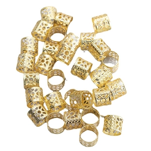 Golden hollow metal dreadlock cuffs with geometric patterns for stylish hair decoration