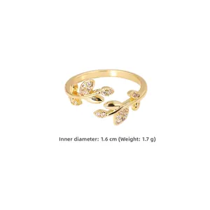 Detail of leaf-shaped gold ring with cubic zirconia showing 1.6cm inner diameter