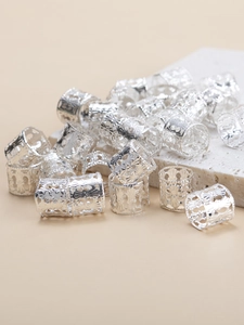 Detailed macro shot of silver vintage hollow spiral hair rings for braids and locs