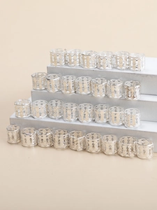 Batch of silver hollow crown hair rings displayed on a tiered stand for braided hair styling