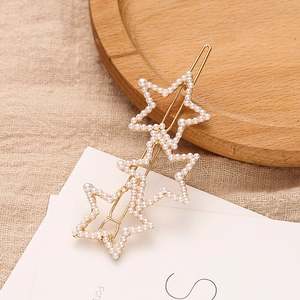 Elegant gold metal hair clip featuring three connected stars with inlaid pearls