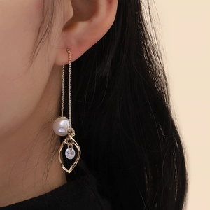 Elegant gold long chain earrings featuring white pearls and zircon leaf pendants