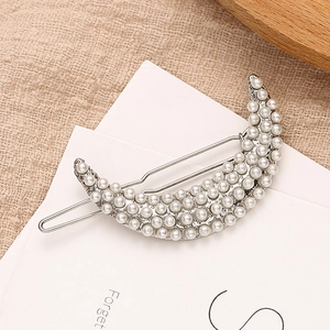 Elegant crescent moon hair clip with white pearls on a silver metal base accessory