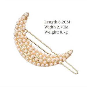Elegant moon-shaped hair clip with inlaid pearls on a gold metal base for women