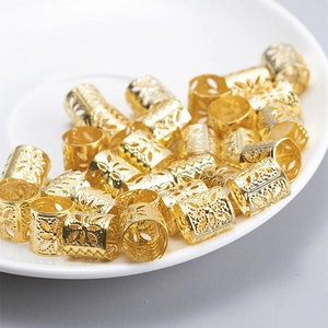 Golden hollow metal hair rings with geometric floral patterns for trendy dreadlocks