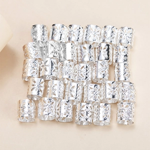 Macro shot of silver hollow-out flower pattern hair rings for dreadlock styling