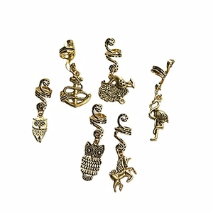 Detailed view of vintage gold hair rings featuring owl, anchor and unicorn charms