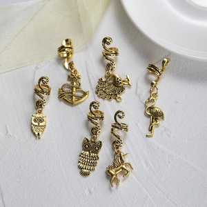 Set of six antique gold hair charms featuring owl and peacock designs for braids