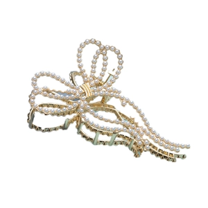Elegant gold bow hair claw clip with white pearls and long hanging pearl tassels