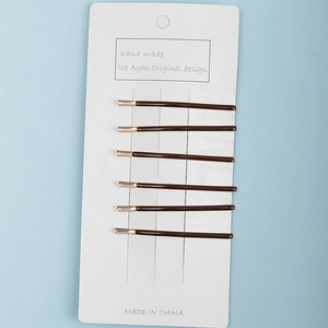 Set of 6 minimalist dark brown hair pins with gold accents on display card