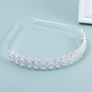 Detail of silver bridal headband featuring intricate woven geometric rhinestone patterns
