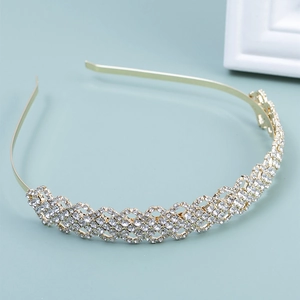 Macro detail of golden bridal headband with sparkling multi-layer rhinestone lattice work