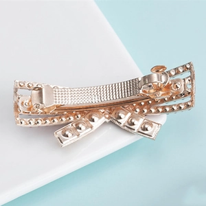 Elegant gold bow hair clip with colorful rhinestones and spring clamp mechanism