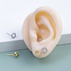 Detailed macro view of 925 silver stud earrings with micro-set cubic zirconia circles
