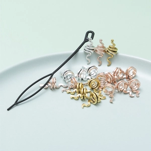 Snake spiral hair rings in gold, silver, and rose gold with a black pull tool for braids