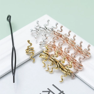 Three colors of snake-shaped alloy hair rings and accessories on a display stand