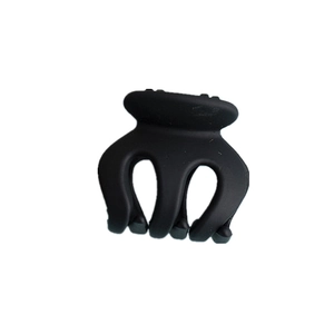 Detail view of a matte black mini hair claw clip with a three-prong design on white background