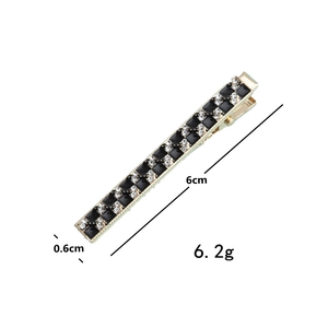 Detailed macro view showing the 6cm golden checkerboard hair clip with rhinestones