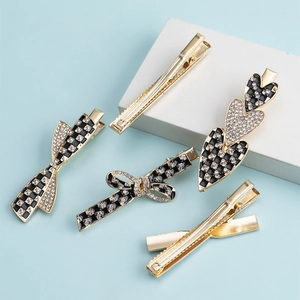 5-piece gold hair clip set with rhinestones and black-white checkerboard heart patterns