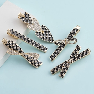 Set of 4 elegant rhinestone hair clips with black checkerboard patterns and golden alloy