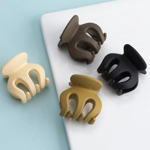 Set of four matte mini hair claw clips in beige, brown, yellow and black for high ponytails
