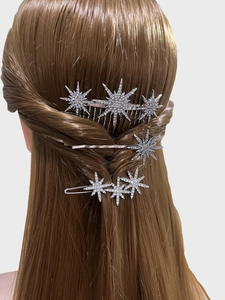Detailed view of silver star hair pin set with sparkling rhinestones on brown hair